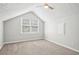 Bedroom features vaulted ceiling, and natural light from the window at 5141 Rocky Run, Stone Mountain, GA 30088