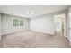 Spacious bedroom with plush carpet and a window view, perfect for relaxation and rest at 5141 Rocky Run, Stone Mountain, GA 30088