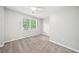Bedroom boasts a ceiling fan, carpet flooring, and a large window for natural light at 5141 Rocky Run, Stone Mountain, GA 30088
