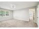 Bright bedroom with plush carpet and natural light, adjacent to a closet and bathroom at 5141 Rocky Run, Stone Mountain, GA 30088