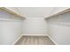 Carpeted walk-in closet with rods and shelving provides generous storage at 5141 Rocky Run, Stone Mountain, GA 30088