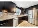 Charming kitchen with stainless steel appliances, granite countertops, tile backsplash and wood-look flooring at 5141 Rocky Run, Stone Mountain, GA 30088