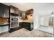 Stylish kitchen featuring dark wood cabinetry, stainless steel appliances, and granite countertops at 5141 Rocky Run, Stone Mountain, GA 30088