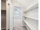Walk-in closet offers built-in shelving and access to additional storage space at 5141 Rocky Run, Stone Mountain, GA 30088