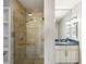 Modern bathroom featuring a tiled shower with glass door and vanity with granite countertop at 195 14Th Ne St # 1706, Atlanta, GA 30309