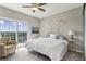 Bedroom boasts balcony access, comfortable chair, and natural light streaming through the sliding doors at 195 14Th Ne St # 1706, Atlanta, GA 30309