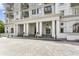 Elegant building entrance with stately columns and decorative landscaping for an inviting arrival at 195 14Th Ne St # 1706, Atlanta, GA 30309