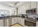 Well-lit kitchen featuring stainless steel appliances, granite countertops, and white cabinetry at 195 14Th Ne St # 1706, Atlanta, GA 30309