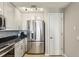 Galley kitchen boasts stainless steel refrigerator, granite countertops, and ample cabinet space at 195 14Th Ne St # 1706, Atlanta, GA 30309