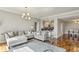 Spacious living area with hardwood floors, a comfortable sofa, and open access to the kitchen at 195 14Th Ne St # 1706, Atlanta, GA 30309