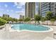 Resort-style pool area with lounge chairs and lush landscaping, set against a backdrop of modern high-rise buildings at 195 14Th Ne St # 1706, Atlanta, GA 30309