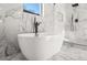 Elegant bathroom featuring a freestanding tub, marble tile, and walk in shower at 2018 Presley Ne Way, Atlanta, GA 30317