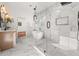 Luxurious bathroom with a glass shower, marble floors, tub, and vanity at 2018 Presley Ne Way, Atlanta, GA 30317