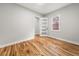 Neutral bedroom with wood floors, large window, and modern white door at 2018 Presley Ne Way, Atlanta, GA 30317