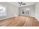 Spacious bedroom with hardwood floors, three windows, and a ceiling fan at 2018 Presley Ne Way, Atlanta, GA 30317
