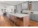 Bright, open kitchen with a large island, gray cabinets, stainless appliances, and hardwood floors at 2018 Presley Ne Way, Atlanta, GA 30317