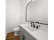 Stylish powder room with wood floors, modern faucet, gray vanity, white countertop, and toilet at 2018 Presley Ne Way, Atlanta, GA 30317