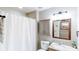 Clean bathroom features tile flooring, vanity, and shower with curtain at 2668 Kings Way, Lawrenceville, GA 30044