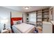 Bedroom featuring a large built-in shelving unit and a plush bed at 2668 Kings Way, Lawrenceville, GA 30044