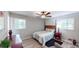 Cozy bedroom features natural light from two windows, ceiling fan, and hardwood flooring at 2668 Kings Way, Lawrenceville, GA 30044