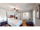 Bedroom with ceiling fan, dark hardwood floors, two windows and connected sitting area at 2668 Kings Way, Lawrenceville, GA 30044