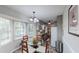 Cozy dining area featuring large windows, a glass table, and a view of the outdoors at 2668 Kings Way, Lawrenceville, GA 30044