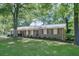 Traditional brick home with red shutters, a covered carport, and mature landscaping at 2668 Kings Way, Lawrenceville, GA 30044
