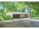 One-story home with a covered carport, brick exterior, and mature trees providing ample shade at 2668 Kings Way, Lawrenceville, GA 30044