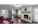 Inviting living room featuring a whitewashed brick fireplace, hardwood floors, and modern decor at 2668 Kings Way, Lawrenceville, GA 30044