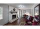 Comfortable living room with a whitewashed brick fireplace, hardwood floors, and stylish decor at 2668 Kings Way, Lawrenceville, GA 30044