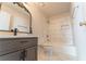 Stylish bathroom featuring a decorative mirror, marble tile, and modern fixtures at 3474 Washington Way, Atlanta, GA 30340