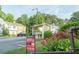 Community shot of condo buildings, mature landscaping, mailbox and for sale sign at 3474 Washington Way, Atlanta, GA 30340