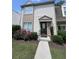 Charming two-story condo with a well-maintained lawn and lovely flower bushes, creating a welcoming curb appeal at 3474 Washington Way, Atlanta, GA 30340
