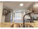 Modern kitchen featuring stainless steel appliances and a view to the dining area for seamless entertaining at 3474 Washington Way, Atlanta, GA 30340
