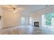 Bright living room featuring modern flooring, a fireplace, and sliding glass doors to outdoor space at 3474 Washington Way, Atlanta, GA 30340