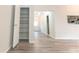 Open-concept living space showcasing modern flooring leading to a kitchen and additional storage at 3474 Washington Way, Atlanta, GA 30340