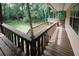 Spacious covered deck with wooden railing and flooring, providing a great view of the fenced-in backyard at 3594 Saddlebrook Dr, Loganville, GA 30052