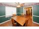 Charming dining area with a wooden table, hardwood floors, and bright natural light at 3594 Saddlebrook Dr, Loganville, GA 30052