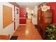 Hallway offers a glimpse of the kitchen and features a unique antique cabinet with wooden-look tile floors at 3594 Saddlebrook Dr, Loganville, GA 30052