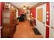 A hallway with wooden tile floors leads to an office space and a white front door at 3594 Saddlebrook Dr, Loganville, GA 30052