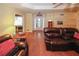 Cozy living room featuring hardwood floors, a tray ceiling and comfortable seating at 3594 Saddlebrook Dr, Loganville, GA 30052
