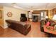 Inviting living room featuring hardwood floors, tray ceilings, fireplace, and comfortable leather furniture at 3594 Saddlebrook Dr, Loganville, GA 30052