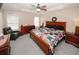 Spacious main bedroom boasts a tray ceiling, cozy furniture, and natural light at 3594 Saddlebrook Dr, Loganville, GA 30052