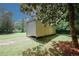 Exterior shot of a metal outbuilding with a roll-up door, situated on a grassy lot with trees at 3594 Saddlebrook Dr, Loganville, GA 30052