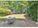 Well-maintained backyard with a patio and mature trees offering ample shade at 3610 Darcy Nw Ct, Kennesaw, GA 30144