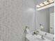 Stylish bathroom features patterned wallpaper, modern vanity, and decorative lighting at 3610 Darcy Nw Ct, Kennesaw, GA 30144