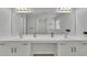 Bright bathroom featuring a double vanity with white cabinets and a large mirror at 3610 Darcy Nw Ct, Kennesaw, GA 30144