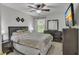 Bedroom with sleek dark wood furniture, a ceiling fan, and a large window at 3610 Darcy Nw Ct, Kennesaw, GA 30144