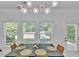 Contemporary dining area with modern light fixture and backyard views through multiple windows at 3610 Darcy Nw Ct, Kennesaw, GA 30144