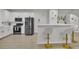 Open concept kitchen with stainless appliances, breakfast bar, and white cabinetry at 3610 Darcy Nw Ct, Kennesaw, GA 30144